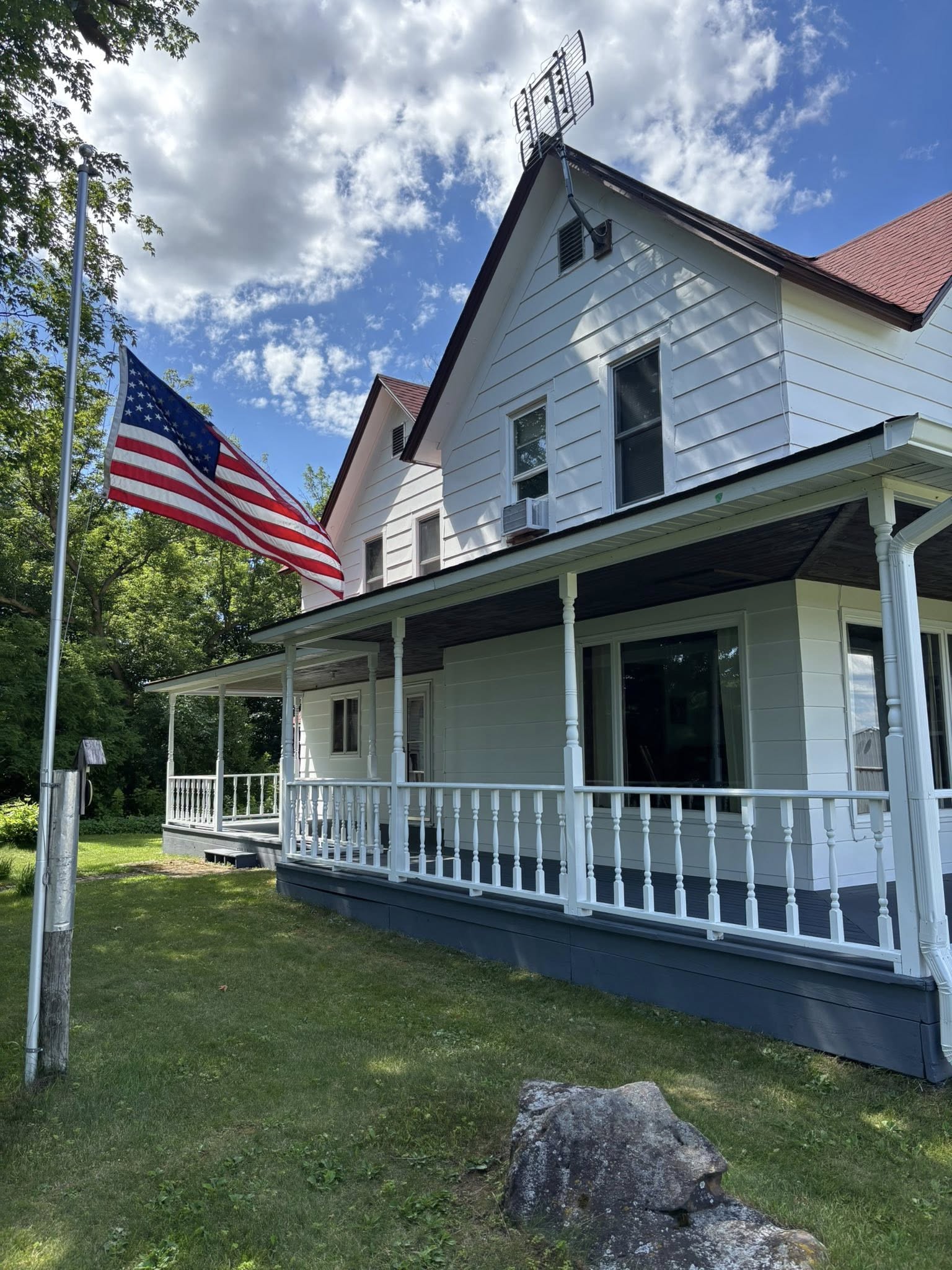 Completed white exterior repaint with dark trim